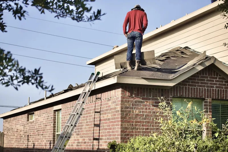 Professional roofer working on a residential roof in Mason